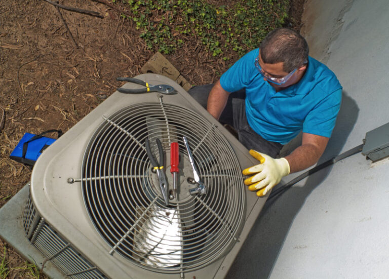 technician repairing ac unit